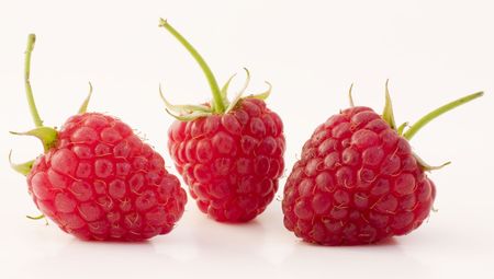 Raspberries fruits with stem and leavesの写真素材