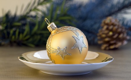 Golden Christmas ball on small plateの写真素材