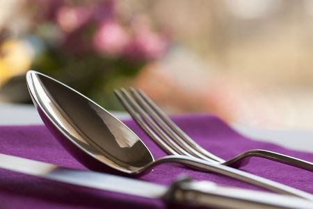 A knife, a spoon, and a fork on table