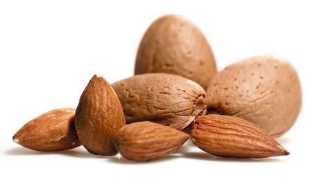 Almonds close up isolated on white backgroundの写真素材