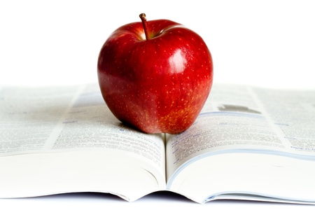 Red  apple placed on the top of the  book.の写真素材