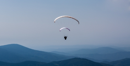 Flying paraglider in the skyの写真素材