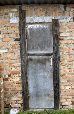 Old door on a brown brick wall great background.の写真素材