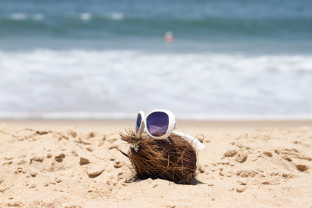 Coconut  and a sunglasses on a beautiful beach. India Goa.の写真素材