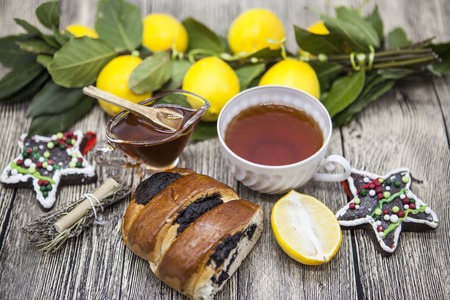 Christmas composition with Cup of tea lemon cookies Christmas toys and honey in a glass vase.の写真素材