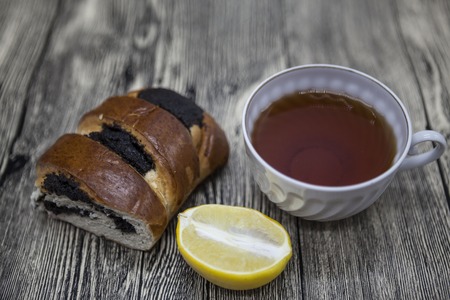 Beautiful composed on wooden background Cup of tea lemon and  biscuits.の写真素材