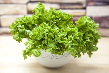 Green new linking of salad in a pot on a wooden background in country kitchen. The best healthy breakfast for the modern personの写真素材