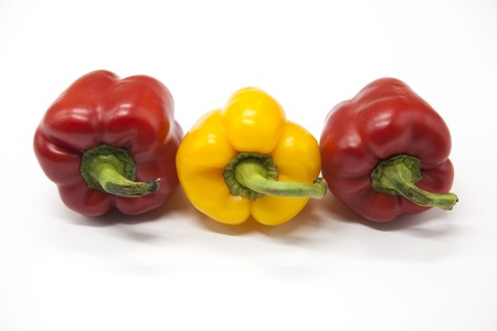 Fresh juicy red  and yellow  sweet pepper close up on a white backgroundの写真素材