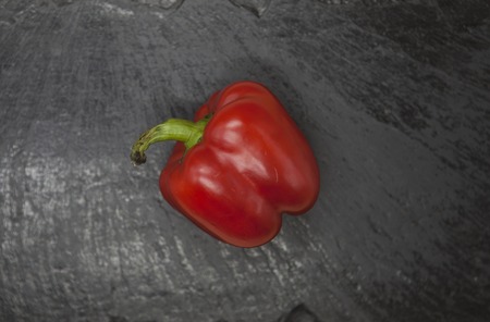 Fresh juicy red sweet pepper close up on a stone background.の写真素材