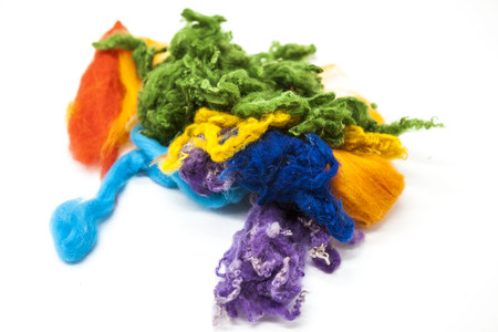 Multi-colored piece of Australian sheep wool Merino breed close-up on a white backgroundの写真素材