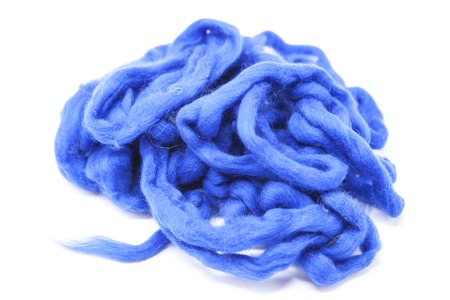 Navy blue piece of Australian sheep wool Merino breed close-up on a white background.の写真素材