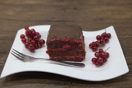Red Velvet, fresh delicious diet cake with red currant at Dukan Diet on a porcelain plate with a...