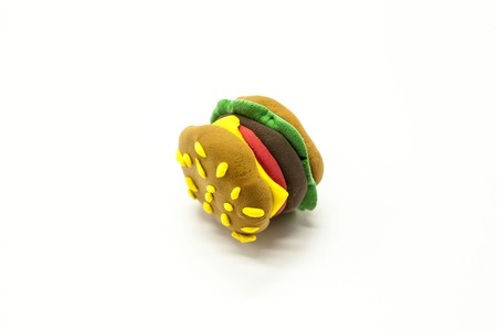 Juicy burger plasticine close-up on a white background, an icon for the Internet, cafe, restaurant.の写真素材