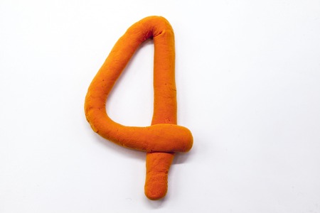 Orange  plasticine figure number four 4 close-up on a white background. The icon for the Internetの写真素材