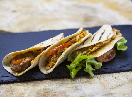 Mexican Tortilla with meat beef and stewed vegetables and spicy sauceの写真素材