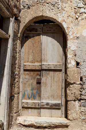 Old door in the stone walls of the village houses. Excellent backgroundの写真素材