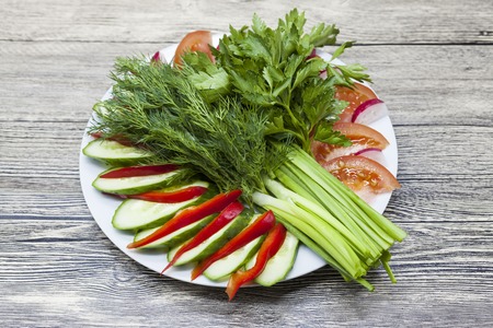 Fresh salad from the farm vegetables. Chopped onion, tomato, cucumber, parsley, cilantro, dill. Eco products without GMF. Products without Genetically Modified Foods.の写真素材