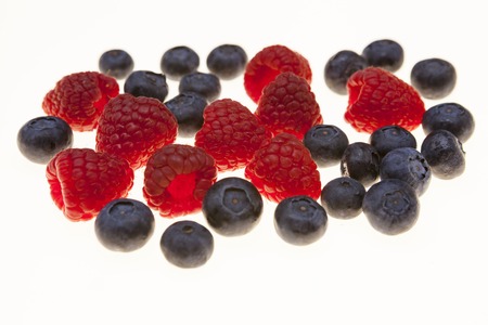 Fresh blueberries, raspberries, closeup on white background. Background for confectionery, cafe fresh berries for pastryの写真素材