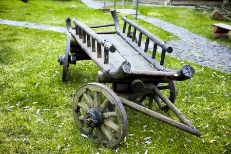 Cart. Old cart on green grass in the back of the house on summer dayの写真素材
