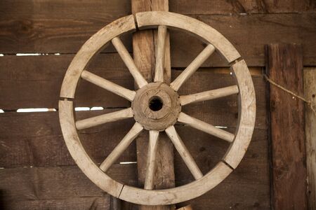 Old wooden cartwheel on a farm.