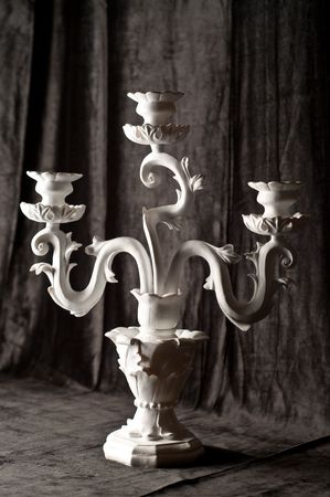 antique candlestick on black velvetの写真素材