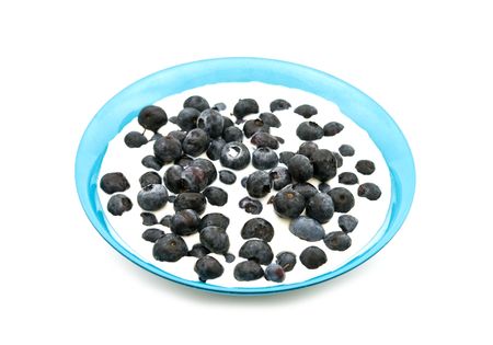 bilberries in milk on white backgroundの写真素材