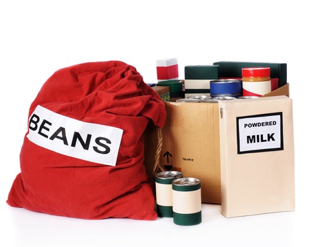 A large bag of beans, a box of powdered milk and multiple containers of non-perishable food to be given to the needy   Isolated on white の写真素材