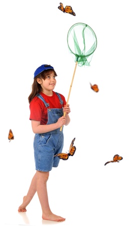 A barefoot elementary girl stalking Monarch butterflies with a butterfly net   Isolated on white の写真素材