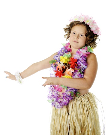 An elementary girl dancing the hula in flower leis and a grass skirt.  On a white background.の写真素材