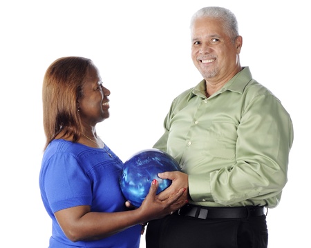 A senior adult couple happily posing with their bowling ball.  On a white background.の写真素材