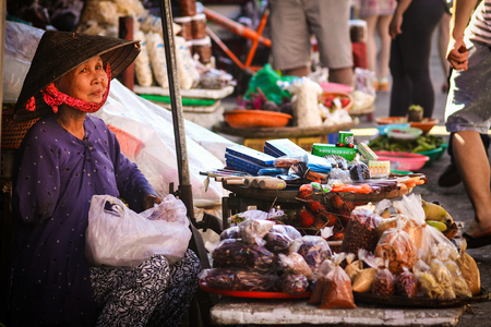 a Lady with one arm is selling cooking tools and spices on the Vietnamese local market in Hoi Anのeditorial素材