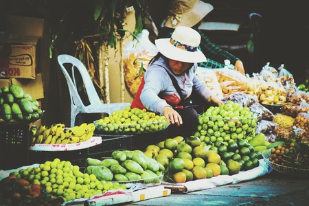 a farmer's wife sells fruit on the roadsideのeditorial素材