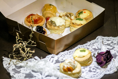 different sweet tartlets in a box