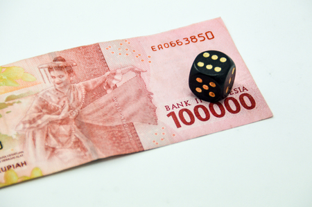 Indonesian paper currency and a diceの写真素材