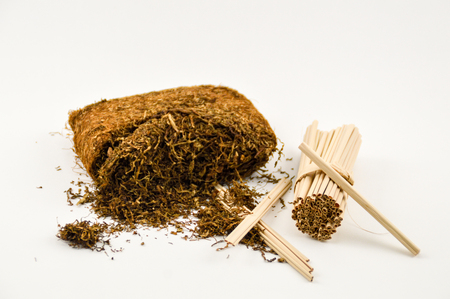 dried Sumatra tobacco with leaves made from palm leaves on a white backgroundの写真素材
