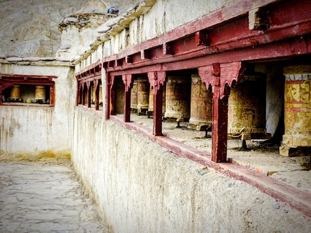 The temple walls of the 3,500-year-old Yuru Monastery in Lamayuru with its prayer wheels, Ladakh, Indiaの写真素材