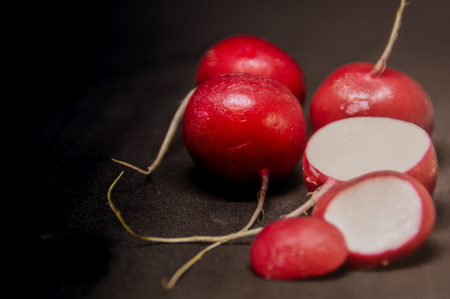 whole and sliced ??raddies on a black backgroundの写真素材