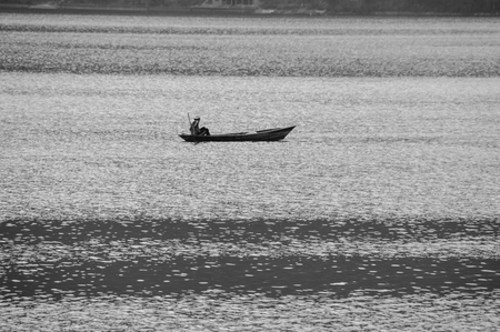 A Nepalese fisherman who goes out to Lake Phewa to catch fishの写真素材