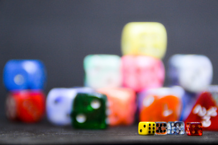 Close-up of different sized, geometric and colored dices