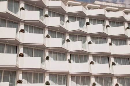 Close up of the symmetry and texture of an apartment building showing economic progress and modernizationの写真素材