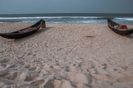 Traditional Vietnamese wooden boats on the shore that shows the effect of lock down, quarantine and social distancing to the livelihood of fishermen due to the covid-19 pandemicの写真素材