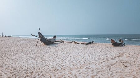 Traditional Vietnamese wooden boats on the shore that shows the effect of covid-19 lock down, quarantine and social distancing to the livelihood of fishermen and the fishing industry of Vietnamの写真素材