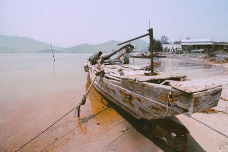 Old wooden vietnamese fishing boat in Qhuy nhon fishing village in Vietnam that shows the local culture and livelihoodの写真素材