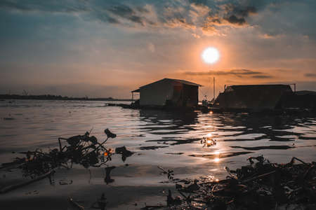 Cinematic scenery of the sunset over the Mekong Delta in Vietnam, showing the daily life and cultureの写真素材