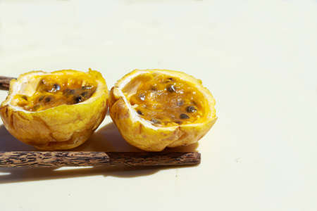 Close up of a yellow passion fruit sliced in half against white backgroundの写真素材