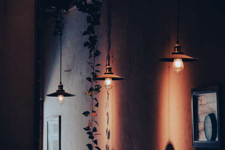 Vintage lamps hanging on a wall in the interior of a building.の写真素材