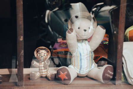 Teddy bear in the shop window. Retro style toned pictureの写真素材