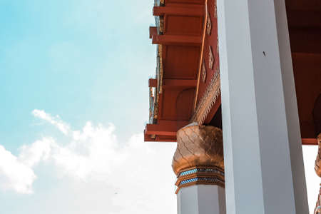 Thai temple roof with blue sky and white clouds, Thailand.