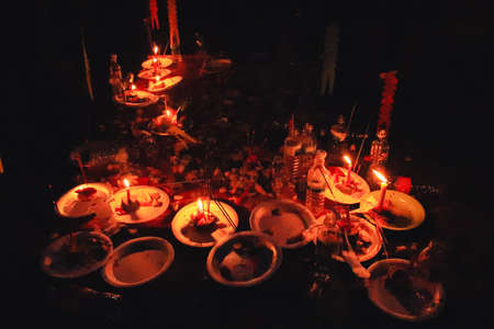 Candles and food offerings during the Pchum Ben Festival or Ancestor's Day in Cambodia