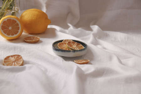 Minimalist still life of fresh and dried lemons showing the concept of freshness, summer aesthetic...